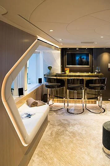 a room with a bed and a table and chairs aboard IRISHA Yacht for Sale