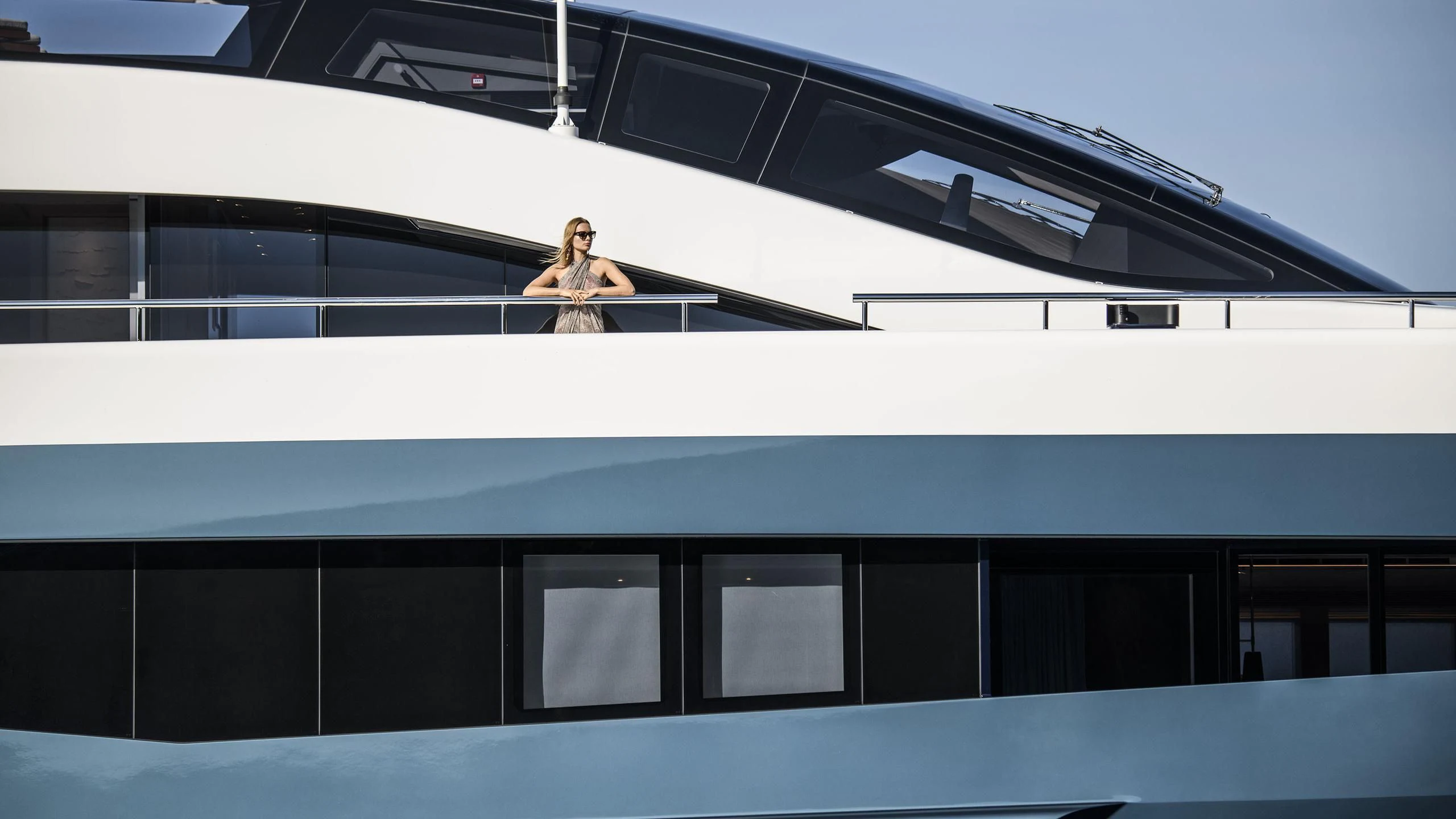 a person standing on a balcony aboard IRISHA Yacht for Sale