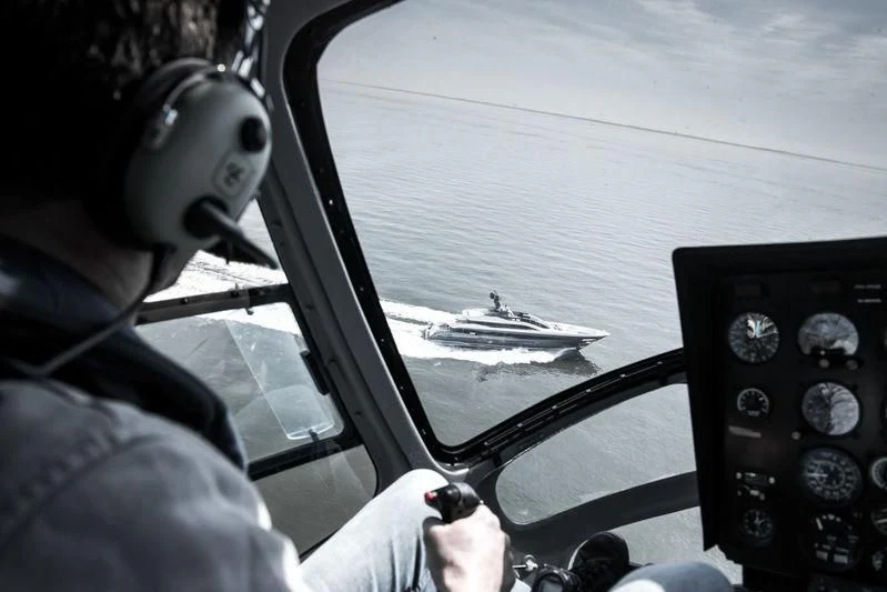 a person wearing headphones driving a car aboard IRISHA Yacht for Sale