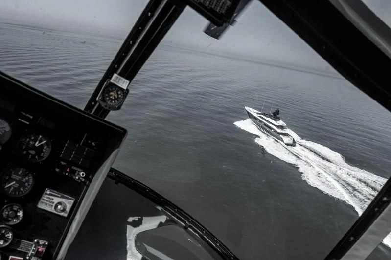 a plane flying over the ocean aboard IRISHA Yacht for Sale