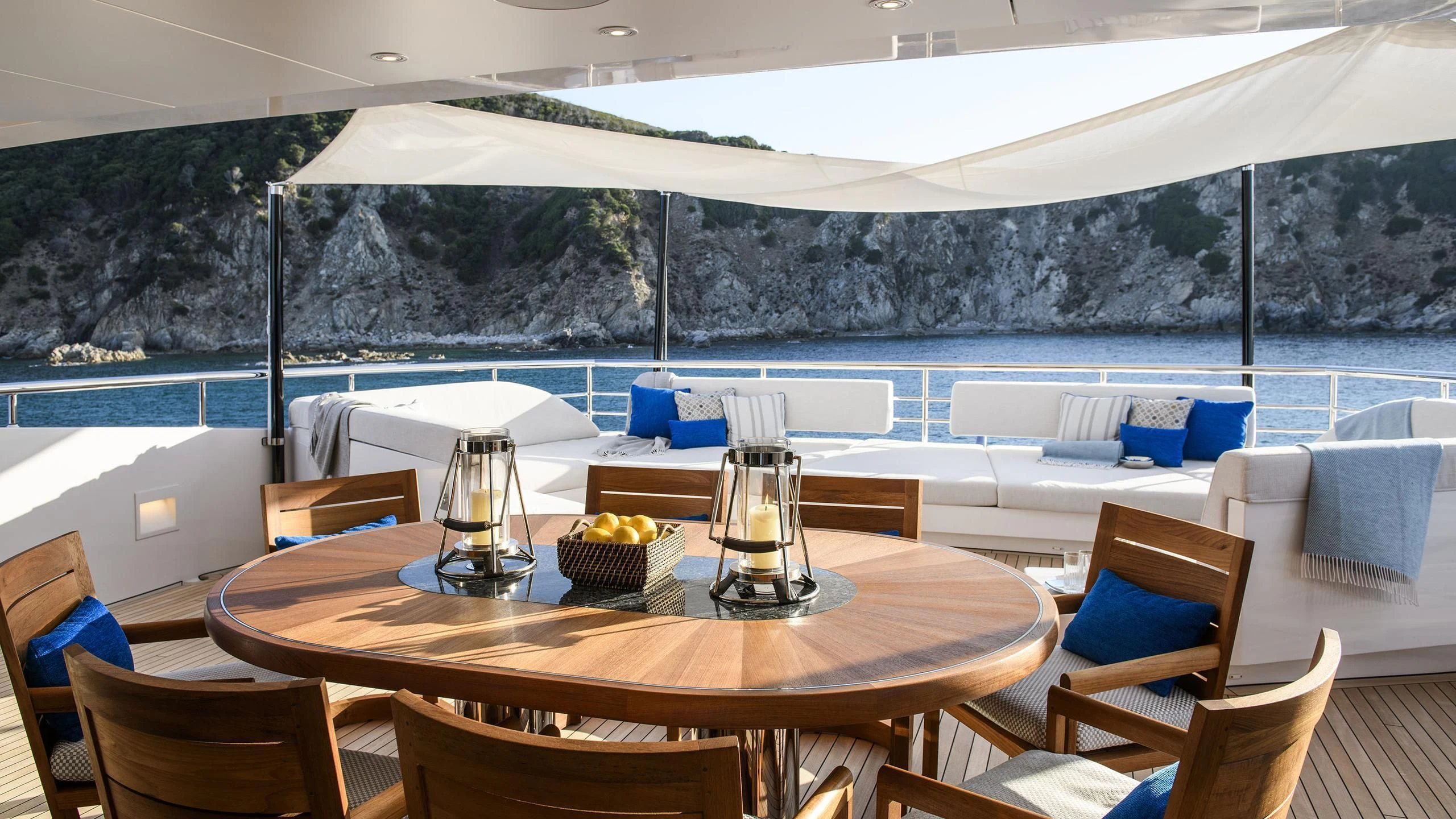 a table with chairs and a large white tent in the background aboard IRISHA Yacht for Sale