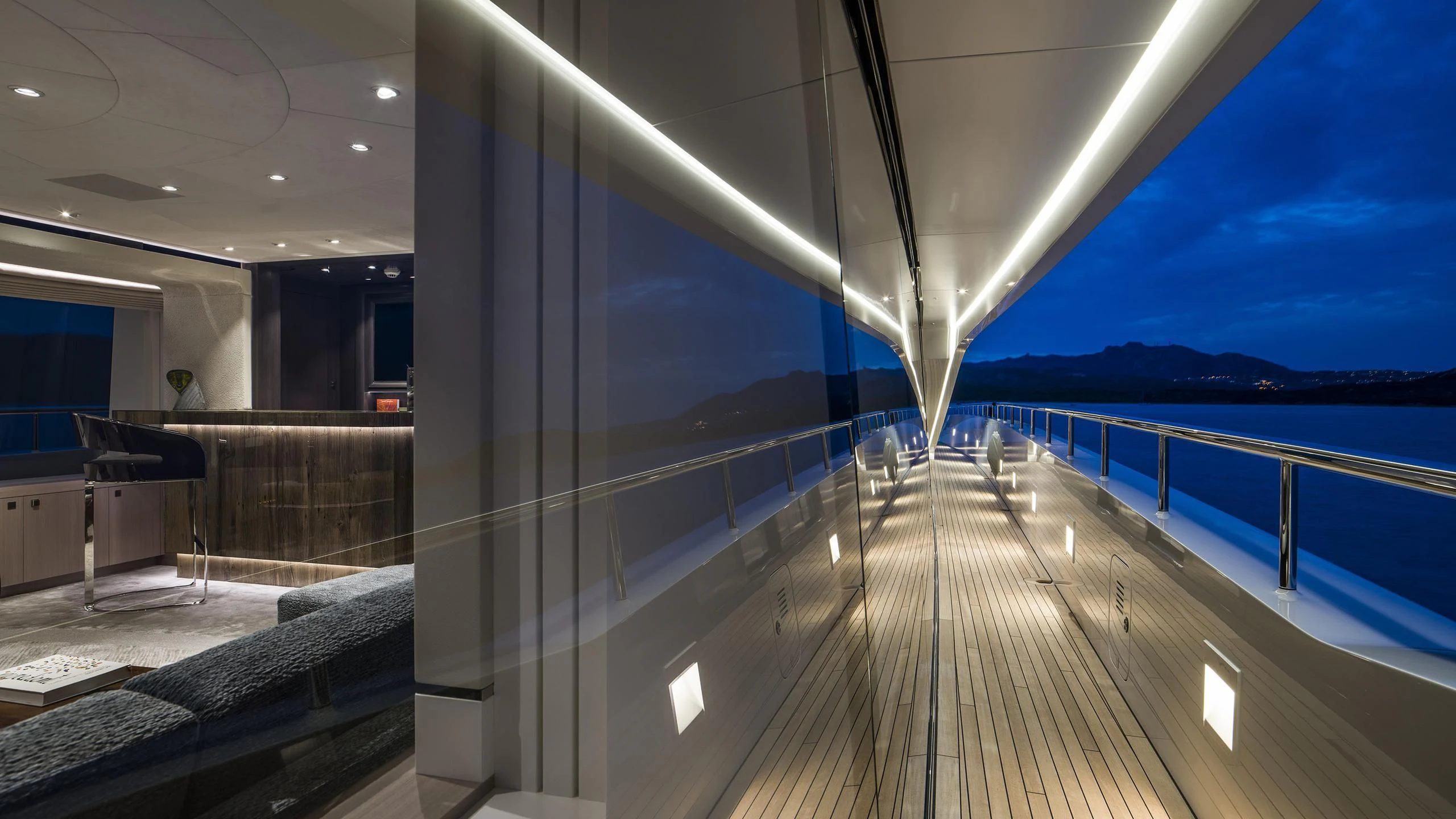 a large glass wall with a deck and a view of the ocean aboard IRISHA Yacht for Sale