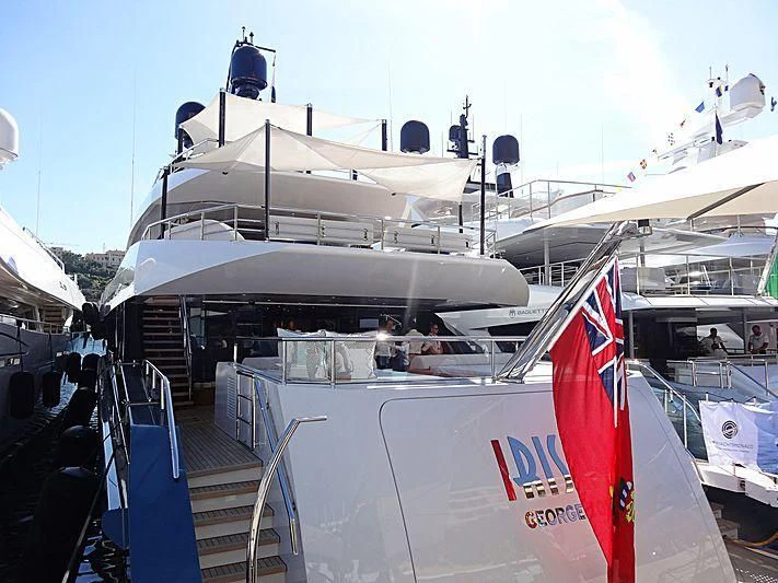 a large white boat with a red stripe on the front aboard IRISHA Yacht for Sale