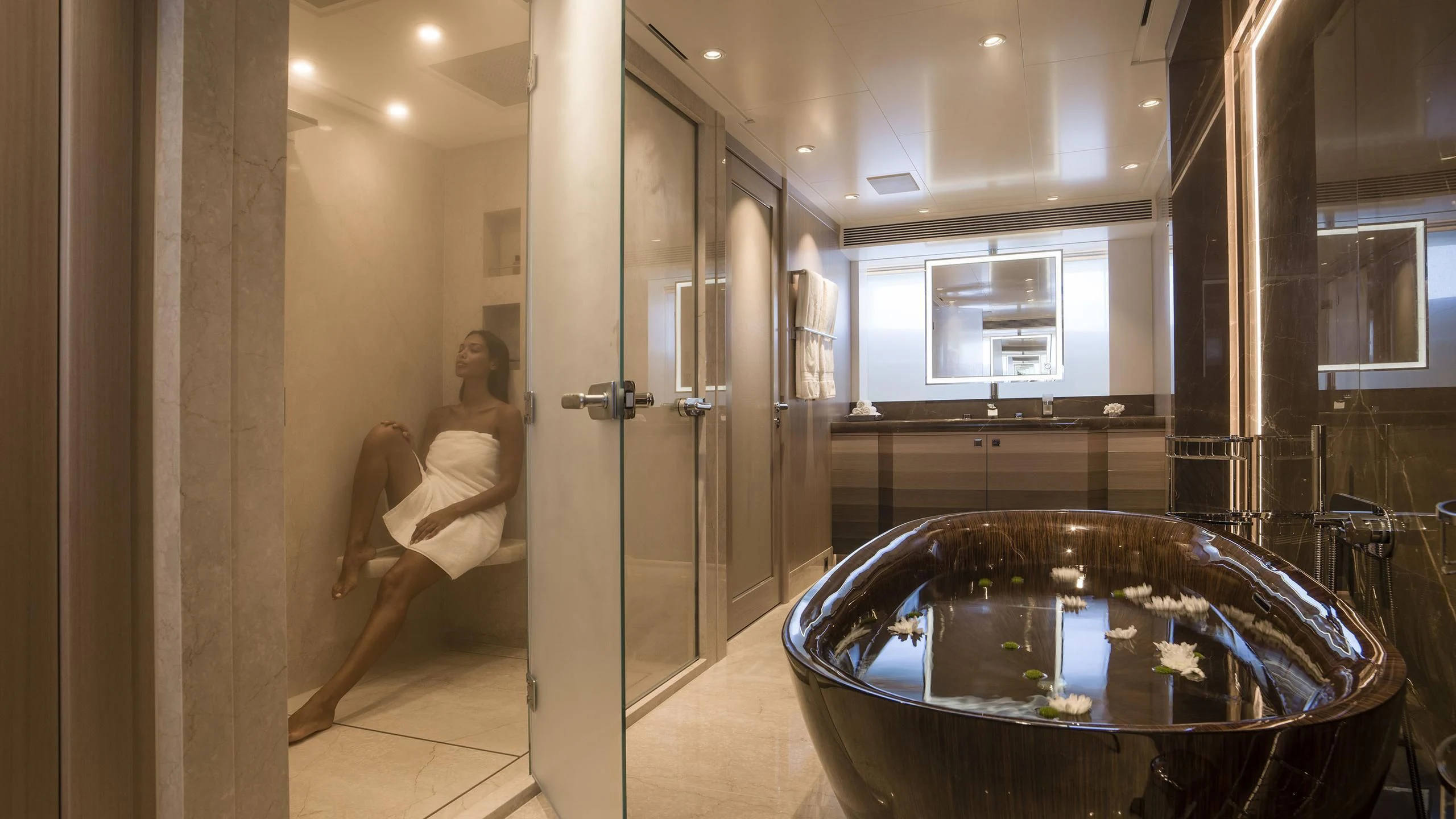 a person sitting in a chair in a bathroom aboard IRISHA Yacht for Sale