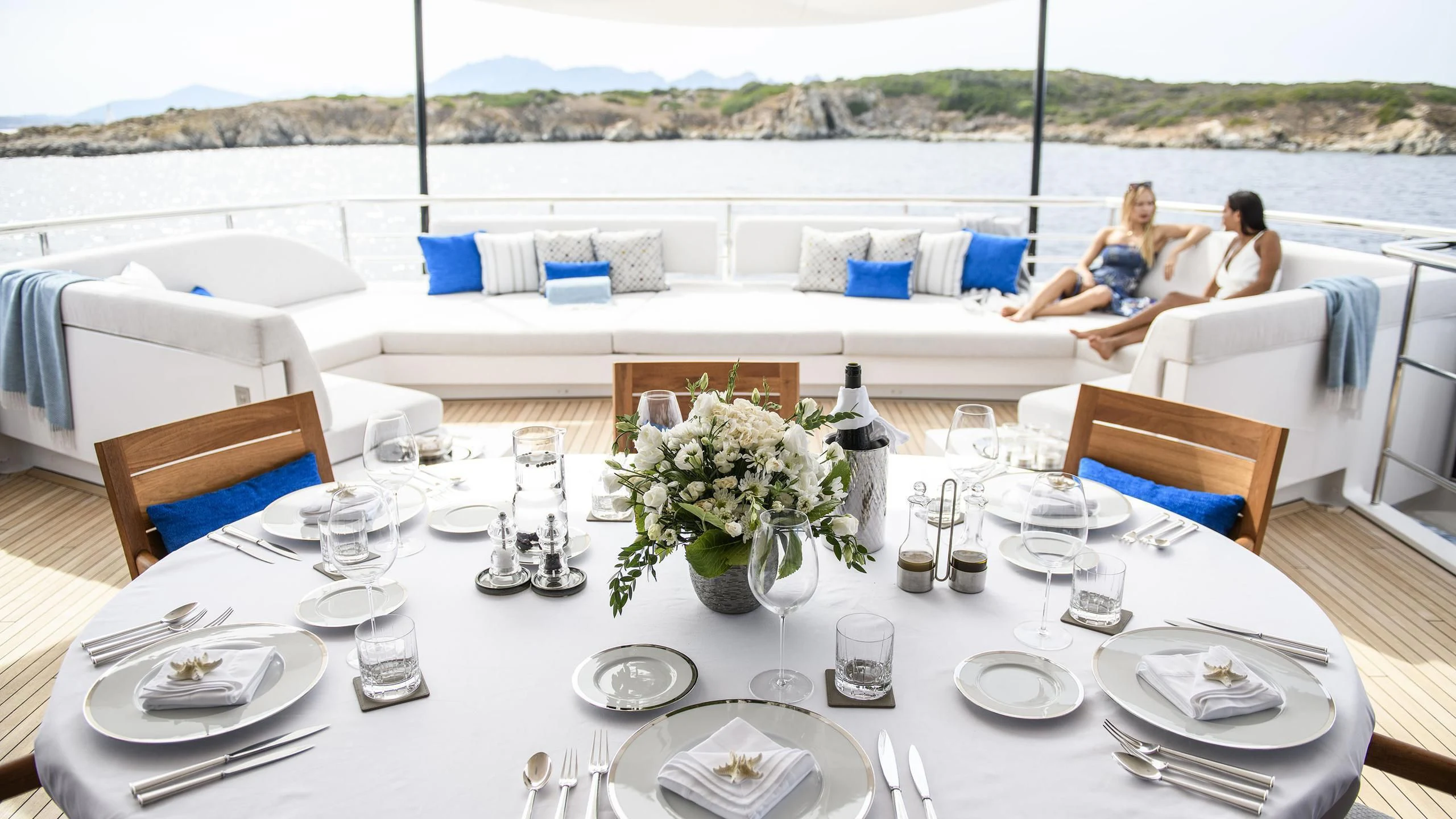 a table set for a dinner aboard IRISHA Yacht for Sale