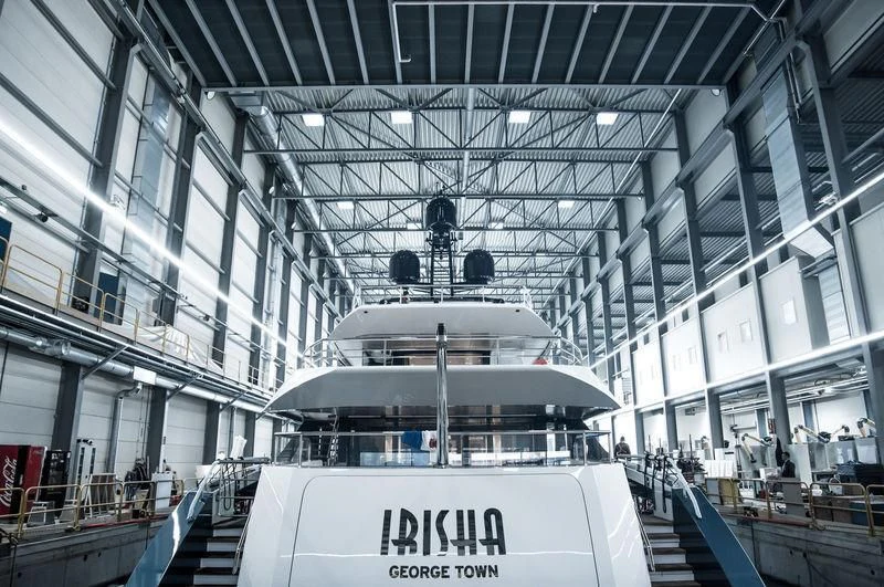 a large white ship in a large building aboard IRISHA Yacht for Sale