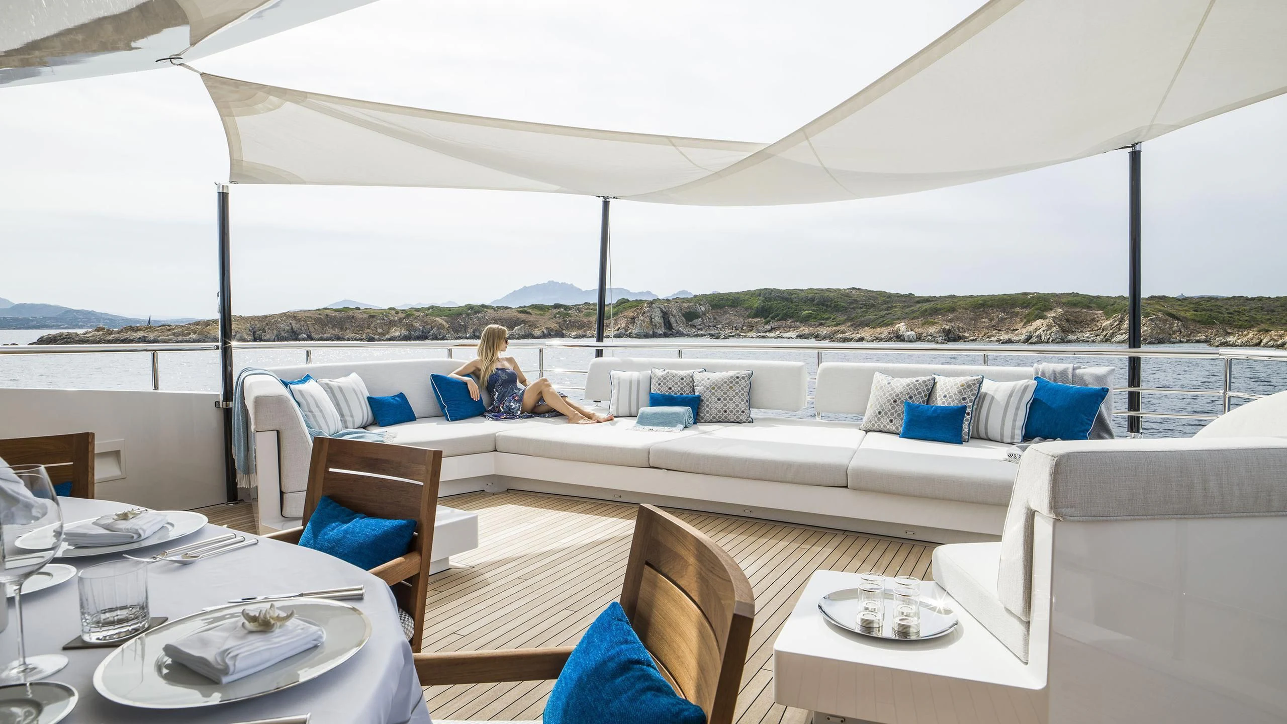 a person sitting on a couch aboard IRISHA Yacht for Sale