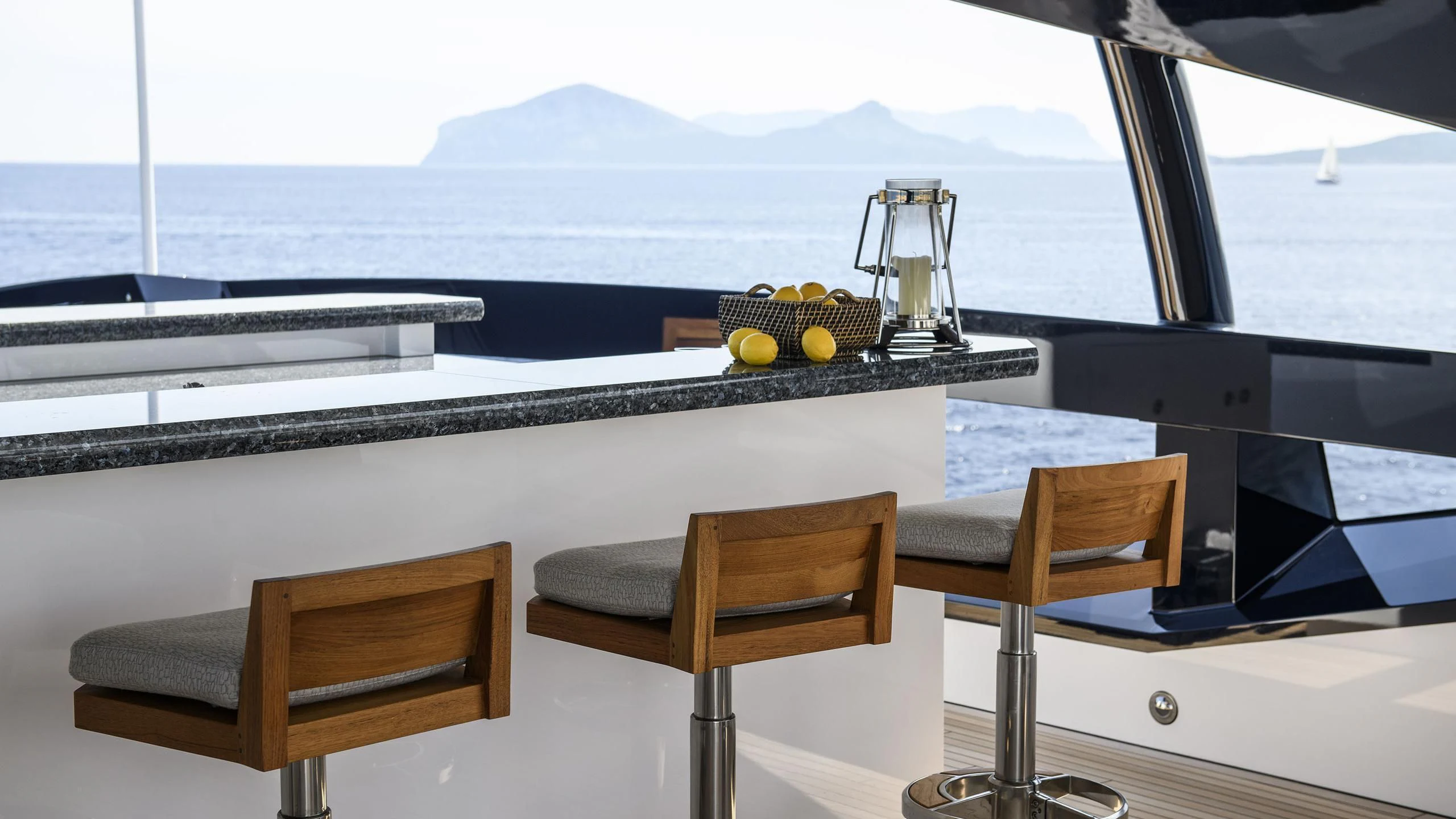 a table with chairs and a glass container on it aboard IRISHA Yacht for Sale