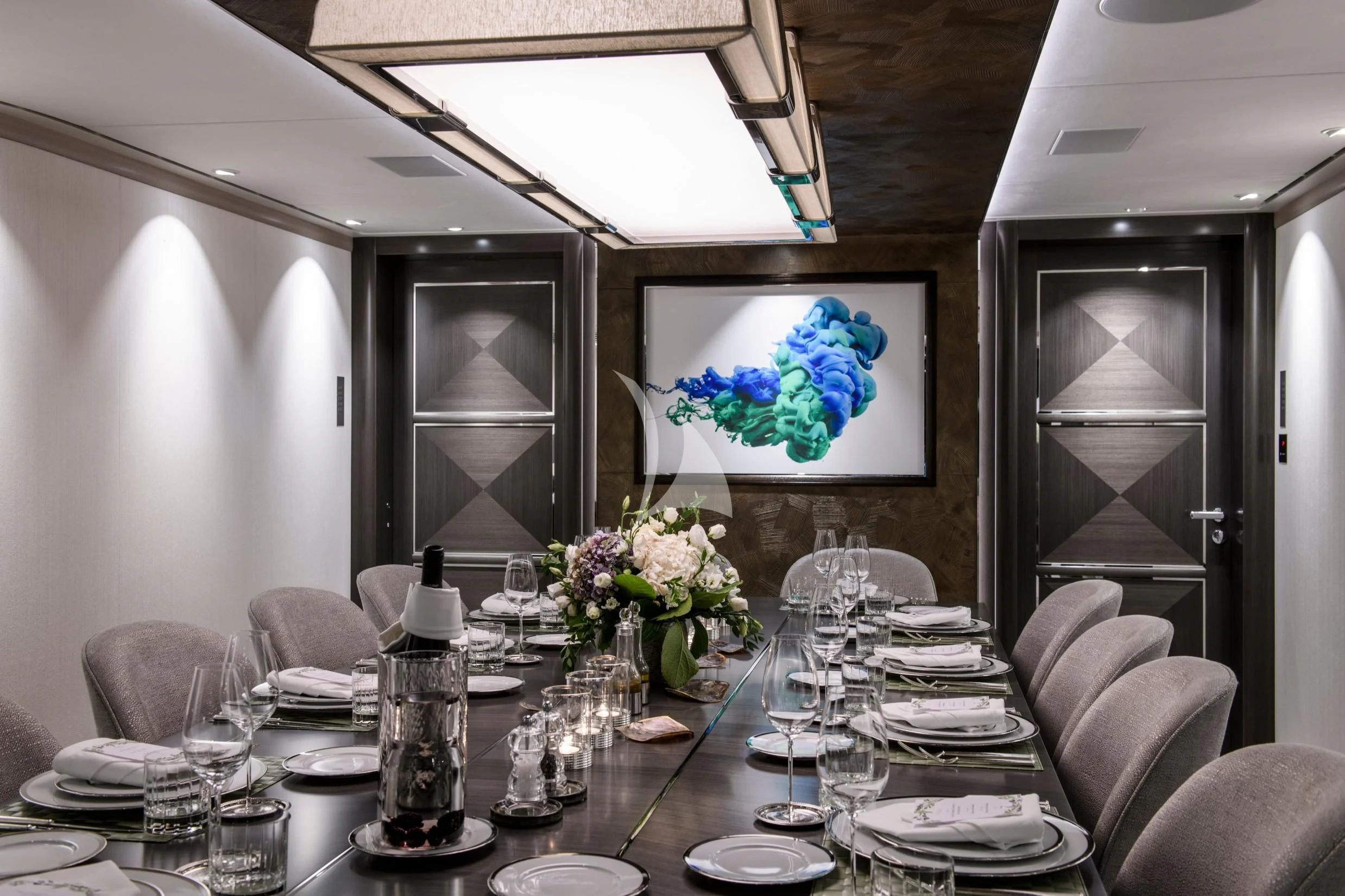 a dining room with a table set for a formal dinner aboard IRISHA Yacht for Sale
