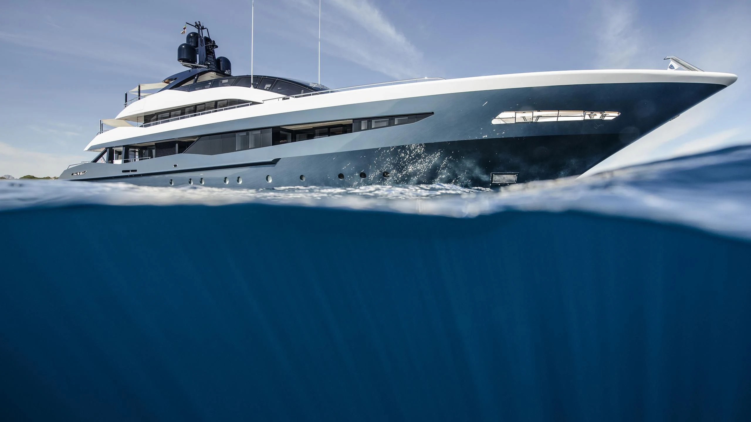 a large white ship in the water aboard IRISHA Yacht for Sale