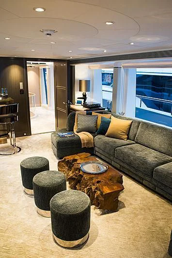 a living room with a couch and coffee table aboard IRISHA Yacht for Sale