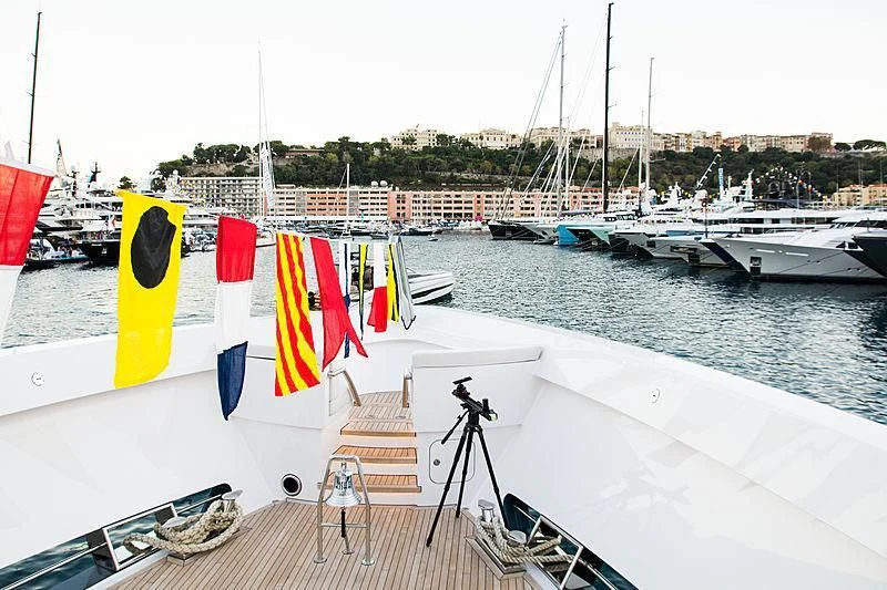 a boat with flags on it aboard IRISHA Yacht for Sale