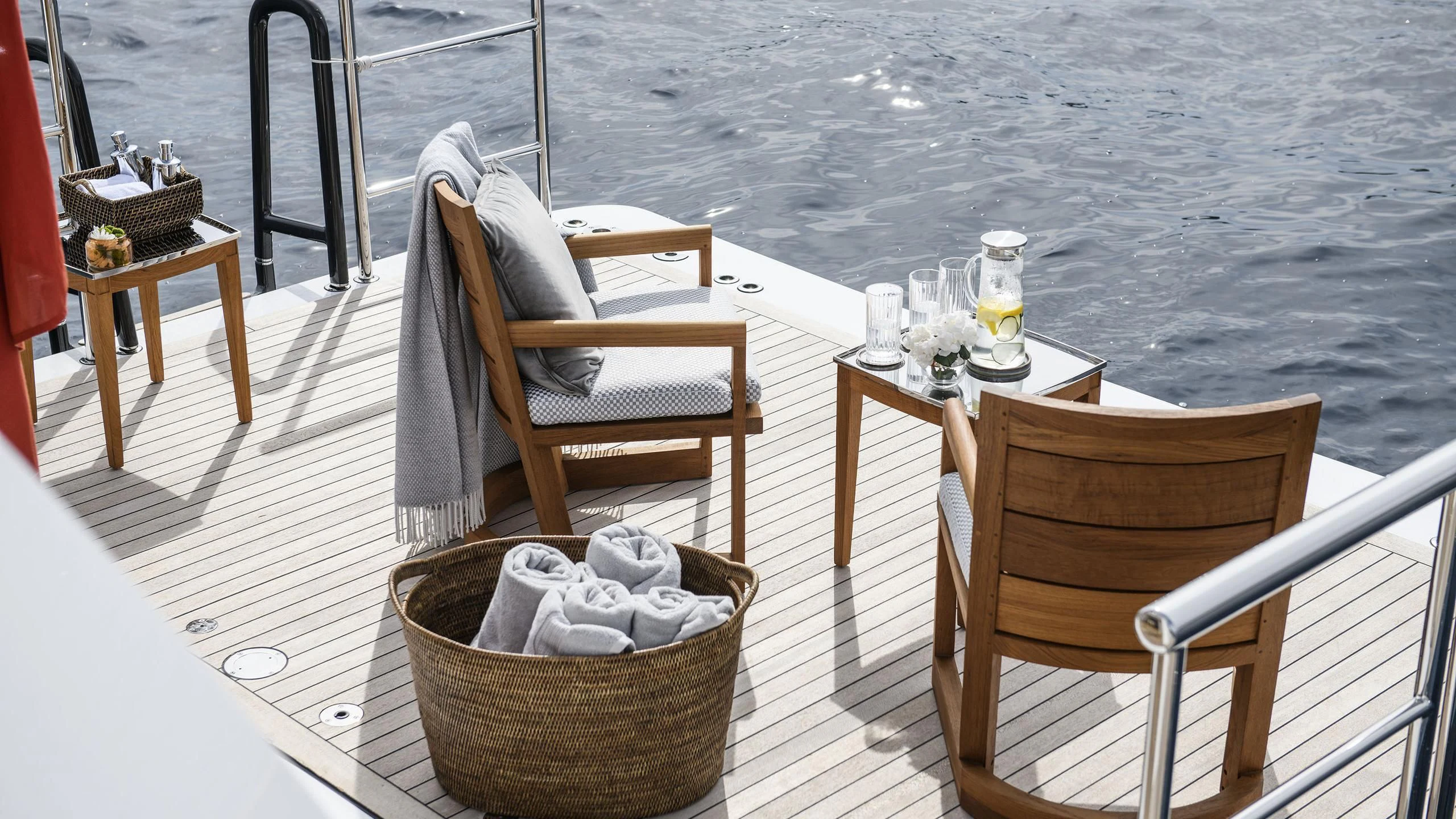 a table and chairs on a deck aboard IRISHA Yacht for Sale