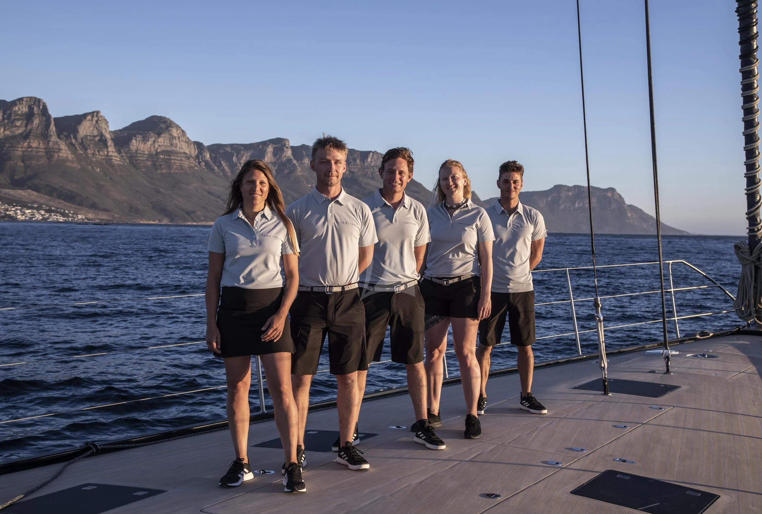 a group of people posing for a photo on a dock aboard SORVIND Yacht for Charter