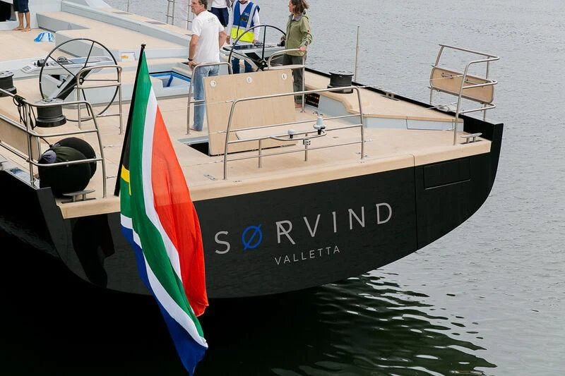 a boat with a flag on the front aboard SORVIND Yacht for Charter