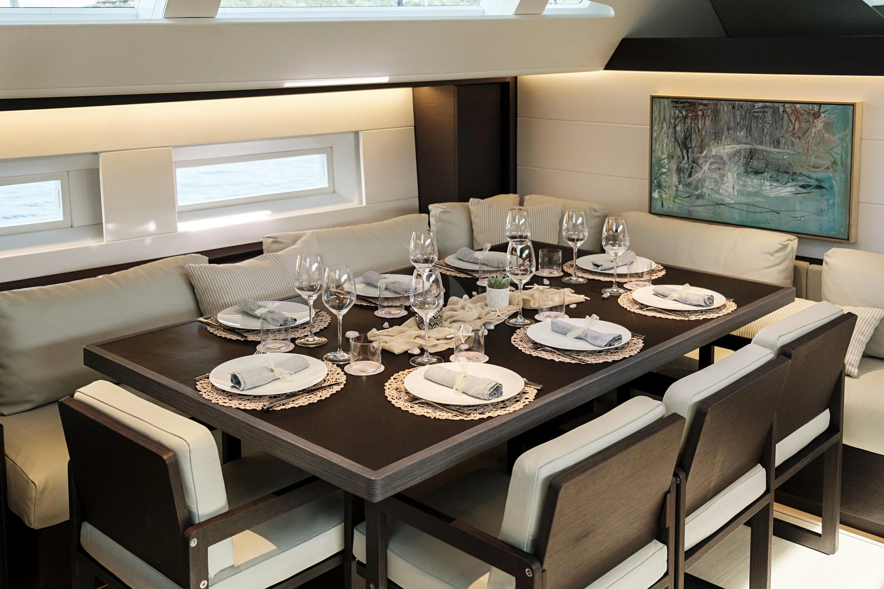 a table set with plates and glasses aboard SORVIND Yacht for Charter