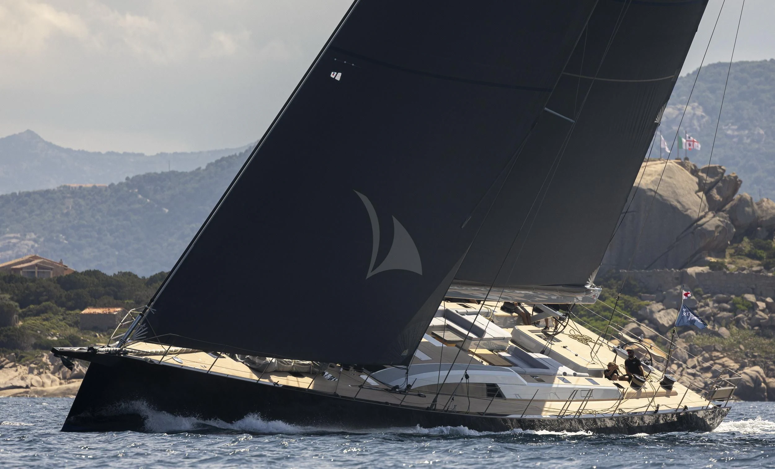 a black and white sailboat on the water aboard SORVIND Yacht for Charter