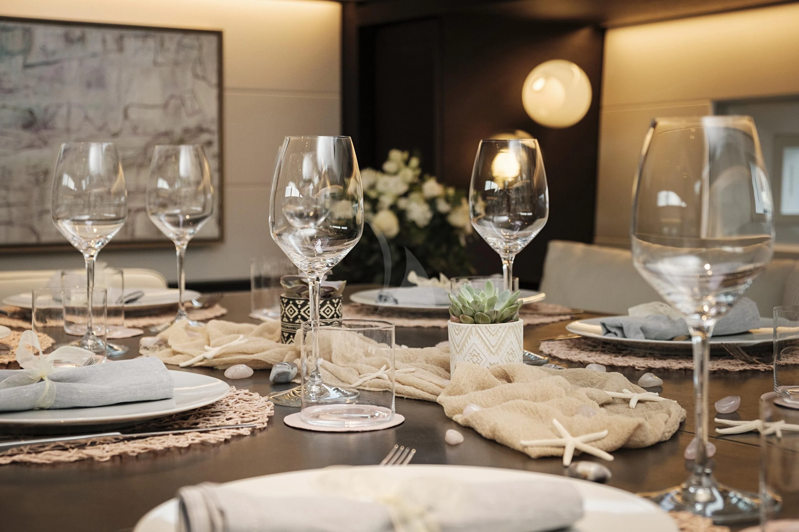a table with food and wine glasses aboard SORVIND Yacht for Charter