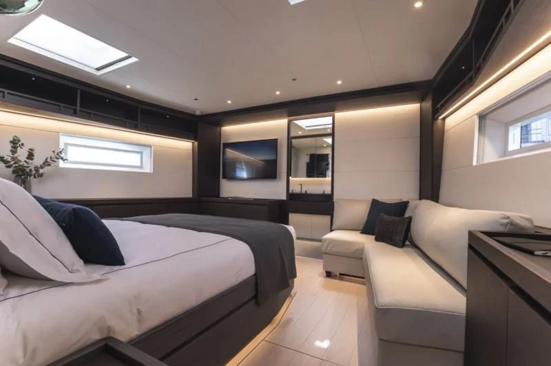 a bedroom with a bed and a couch aboard SORVIND Yacht for Charter