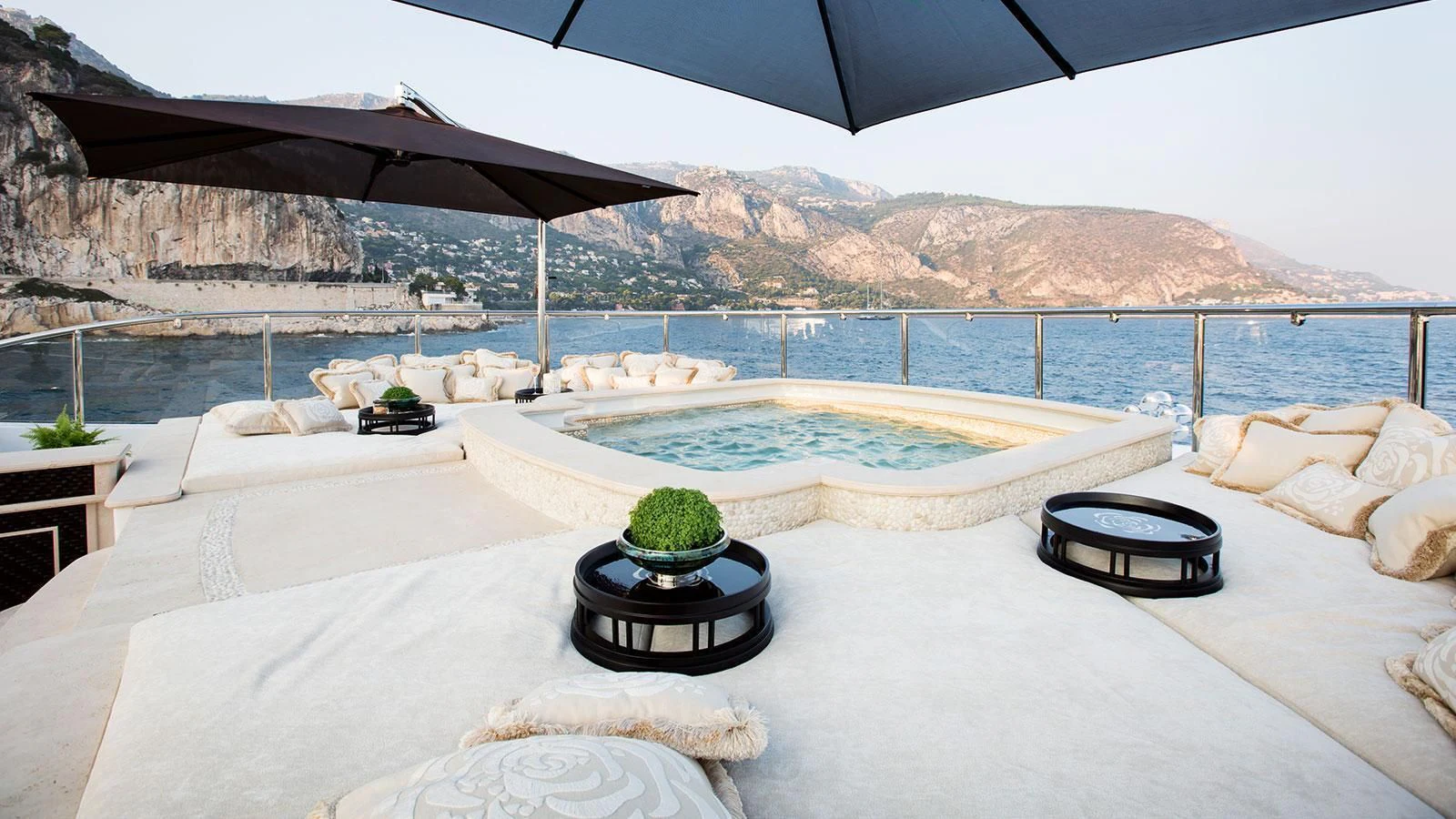 a pool with a table and a chair on a beach aboard ILLUSION V Yacht for Charter