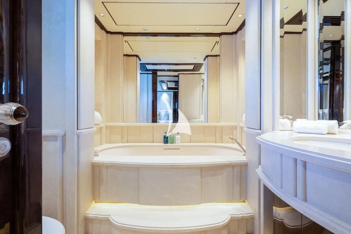a bathroom with a tub sink and toilet aboard ILLUSION V Yacht for Charter