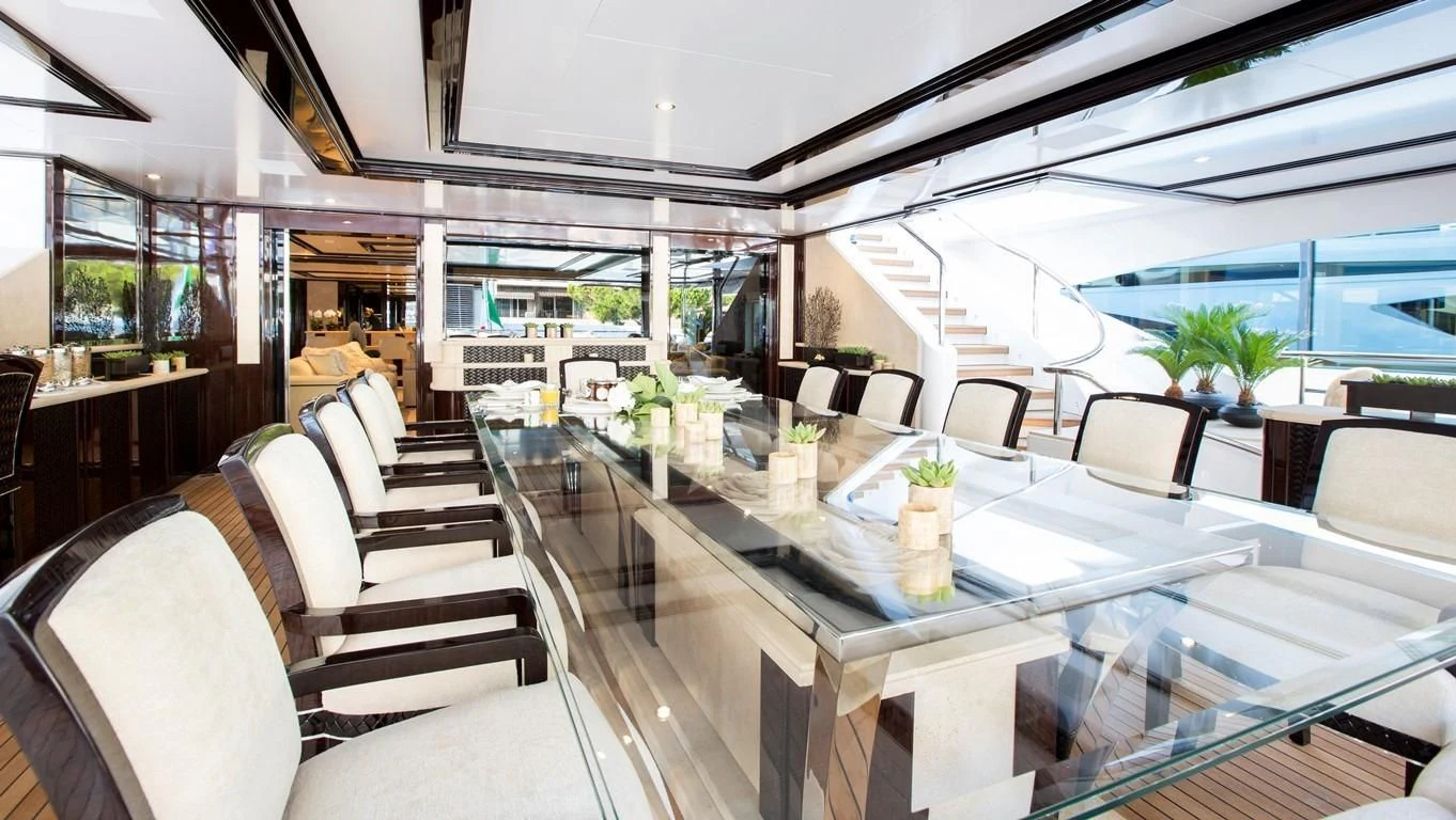 a room with tables and chairs aboard ILLUSION V Yacht for Charter