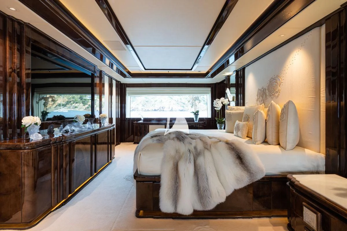 a room with a bed and a desk aboard ILLUSION V Yacht for Charter