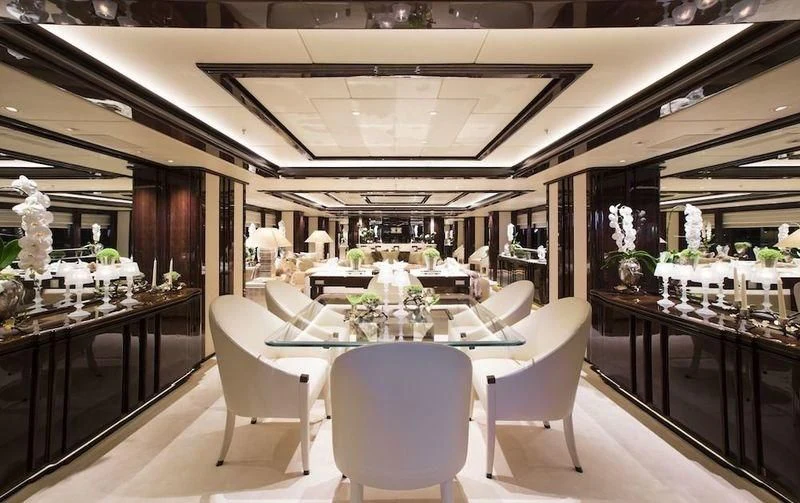 a restaurant with tables and chairs aboard ILLUSION V Yacht for Charter