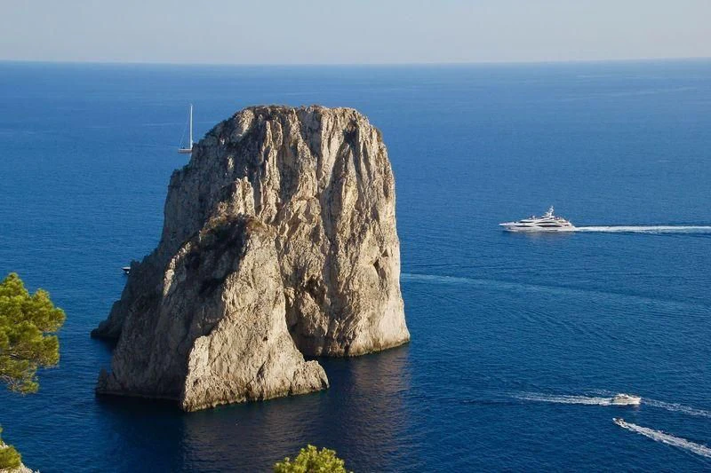 a large rock in the middle of the ocean aboard ILLUSION V Yacht for Charter