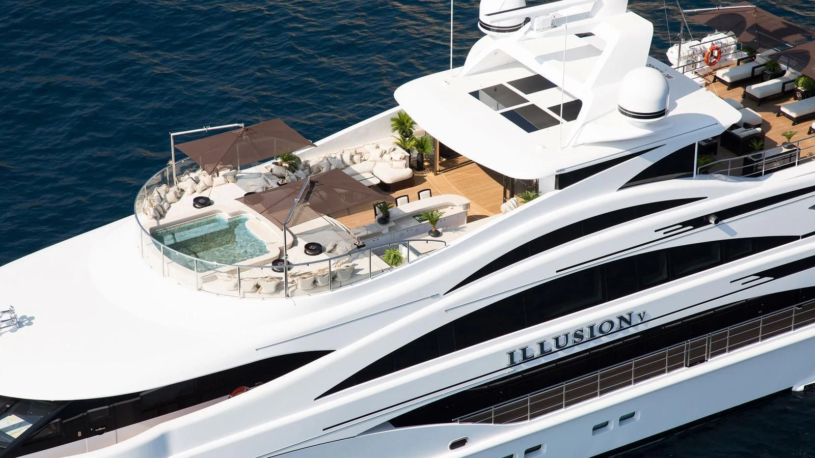 a white yacht on the water aboard ILLUSION V Yacht for Charter
