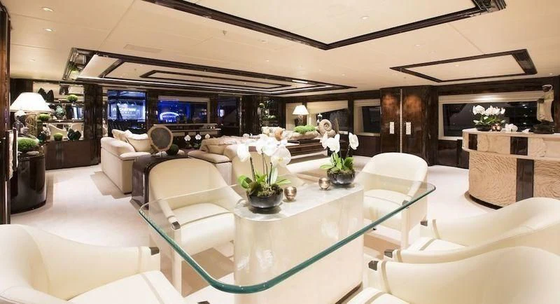 a large living room with a large screen aboard ILLUSION V Yacht for Charter