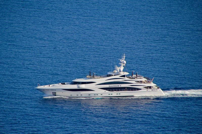a white yacht in the water aboard ILLUSION V Yacht for Charter