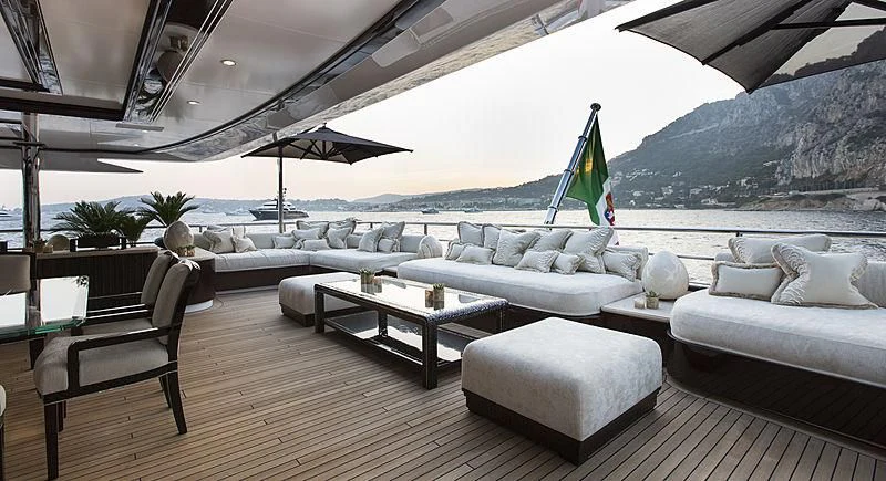 a living room with a large sofa and a table aboard ILLUSION V Yacht for Charter