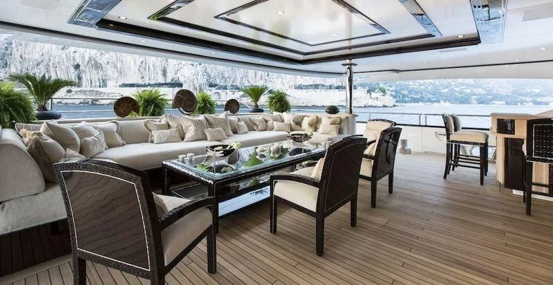 a room with a table and chairs aboard ILLUSION V Yacht for Charter