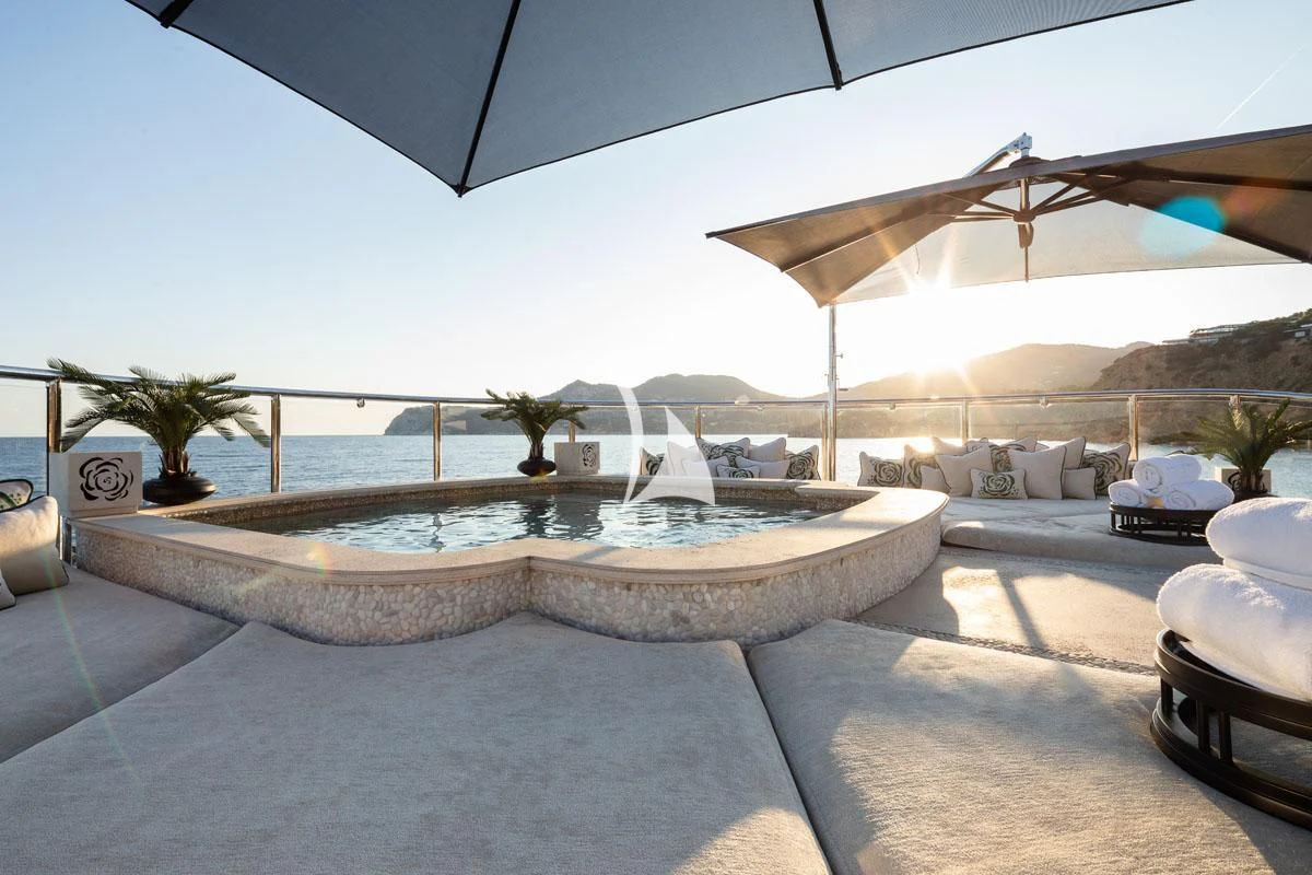 a large patio with a pool and umbrella aboard ILLUSION V Yacht for Charter