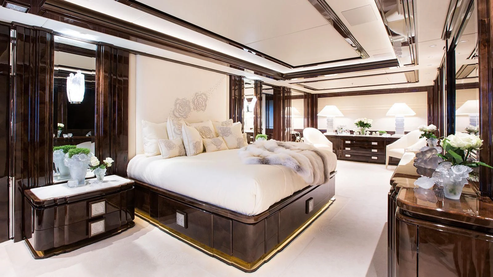 a large bedroom with a large bed aboard ILLUSION V Yacht for Charter