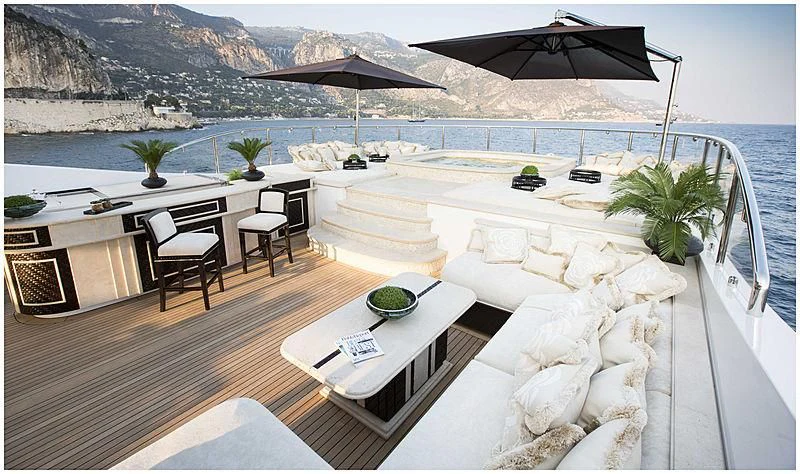 a patio with a table and chairs aboard ILLUSION V Yacht for Charter