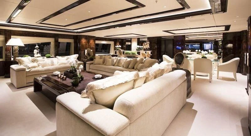 a living room with a couch and a table aboard ILLUSION V Yacht for Charter