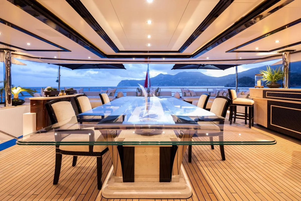a large room with a table and chairs aboard ILLUSION V Yacht for Charter