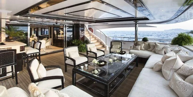 a living room with a large patio aboard ILLUSION V Yacht for Charter