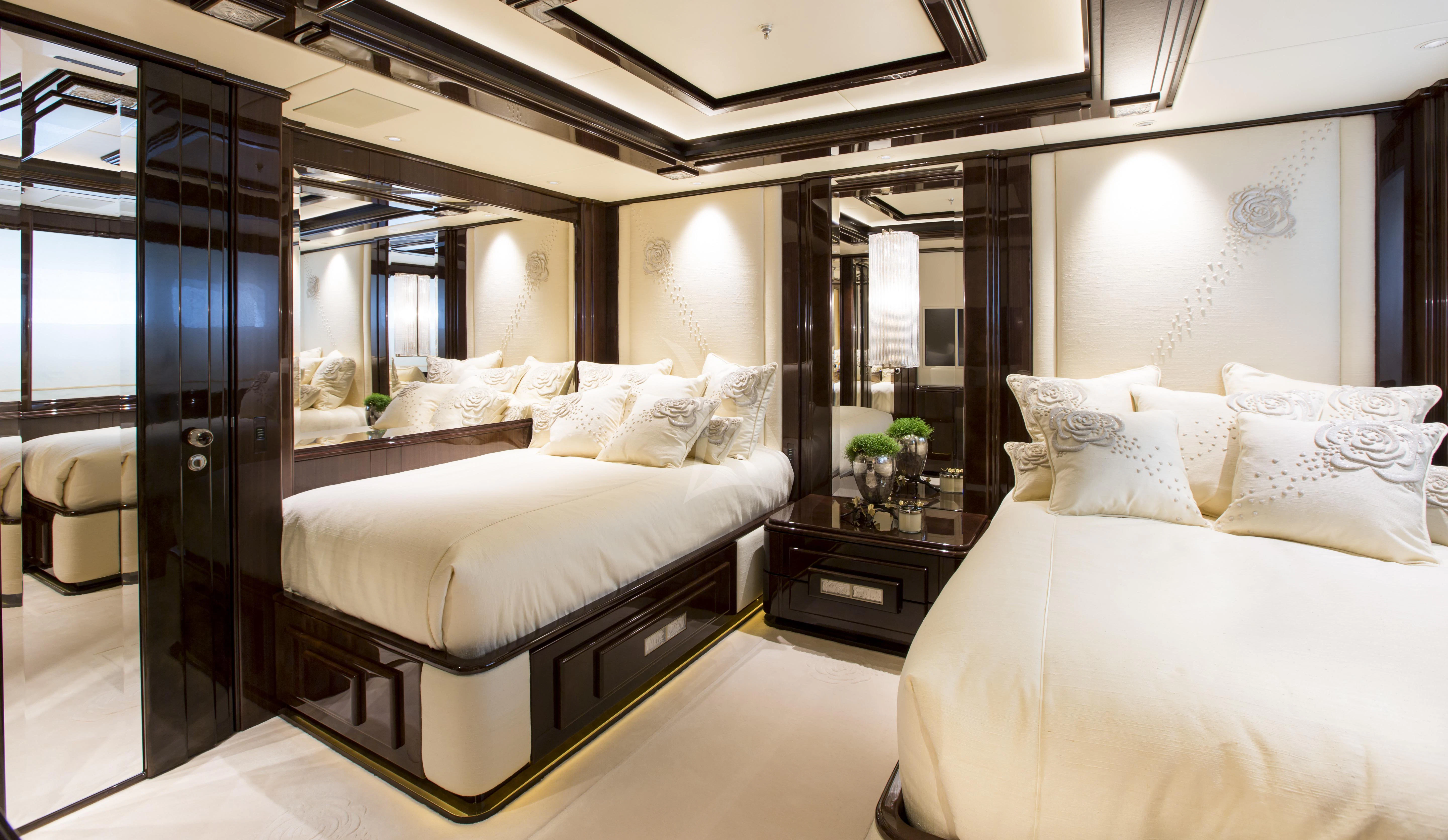 a room with a bed and a mirror aboard ILLUSION V Yacht for Charter