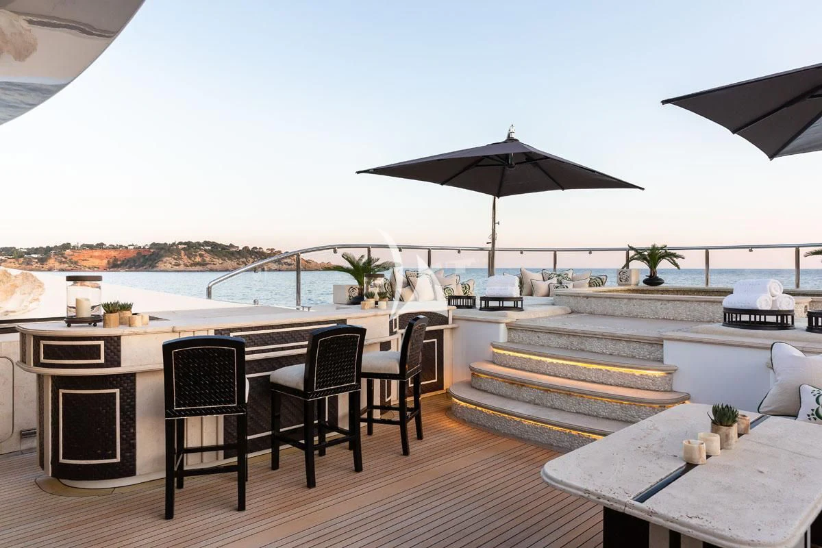a patio with a table and chairs aboard ILLUSION V Yacht for Charter