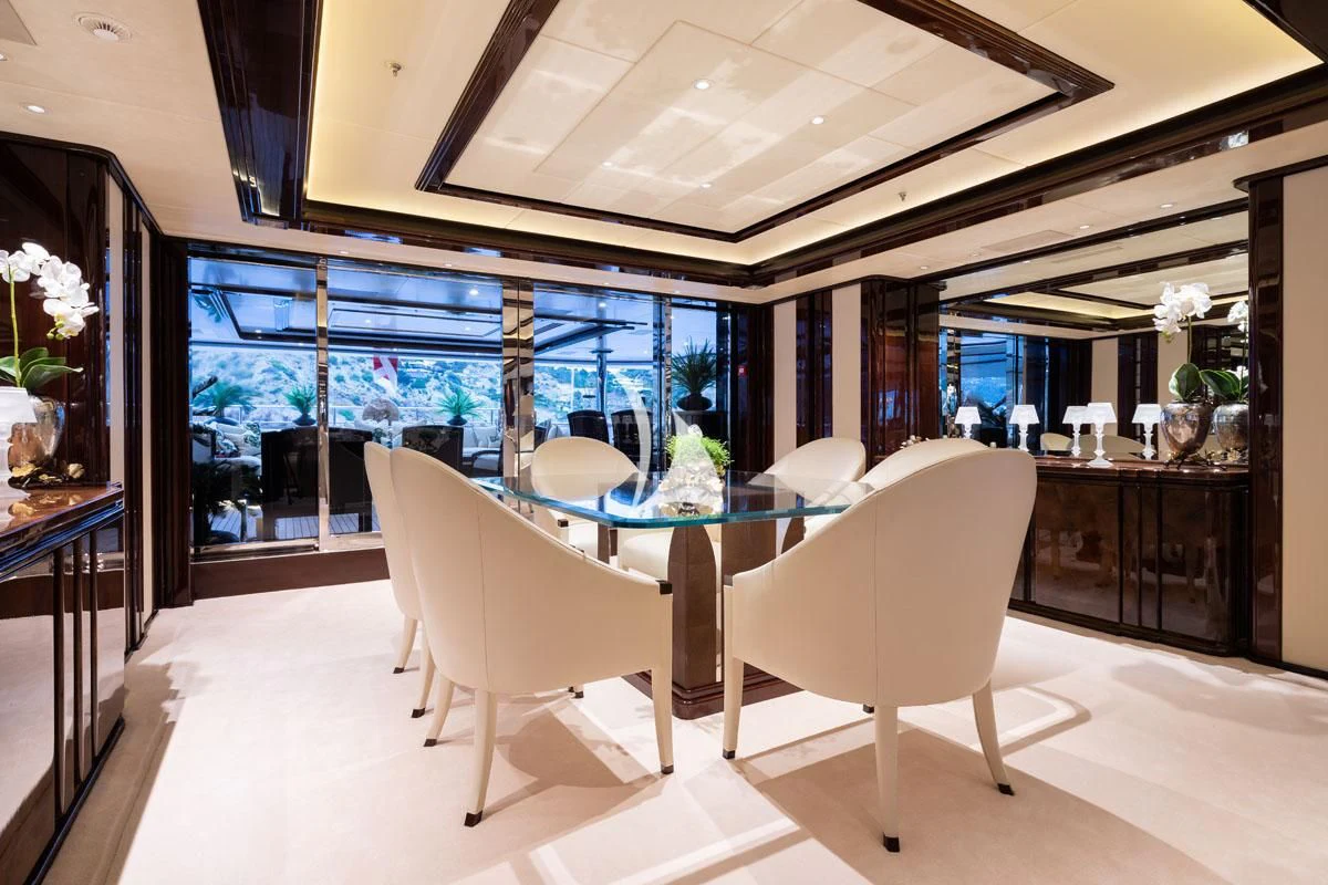 a room with a table and chairs aboard ILLUSION V Yacht for Charter