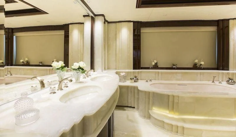 a bathroom with a large mirror aboard ILLUSION V Yacht for Charter