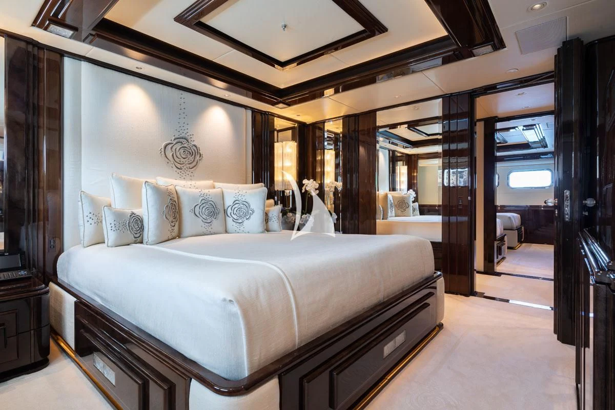 a bedroom with a large bed aboard ILLUSION V Yacht for Charter