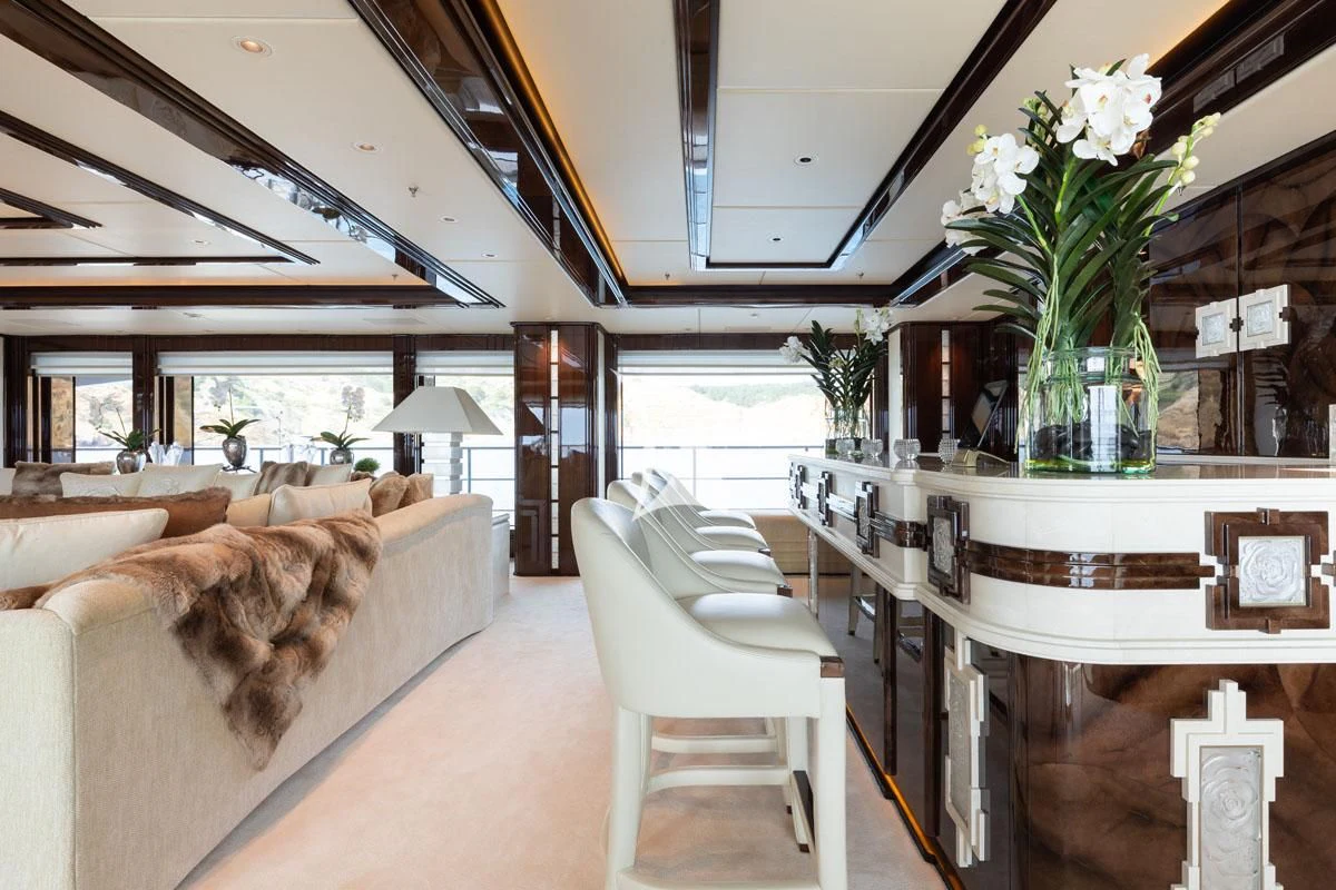 a large room with a table and chairs and a plant in it aboard ILLUSION V Yacht for Charter