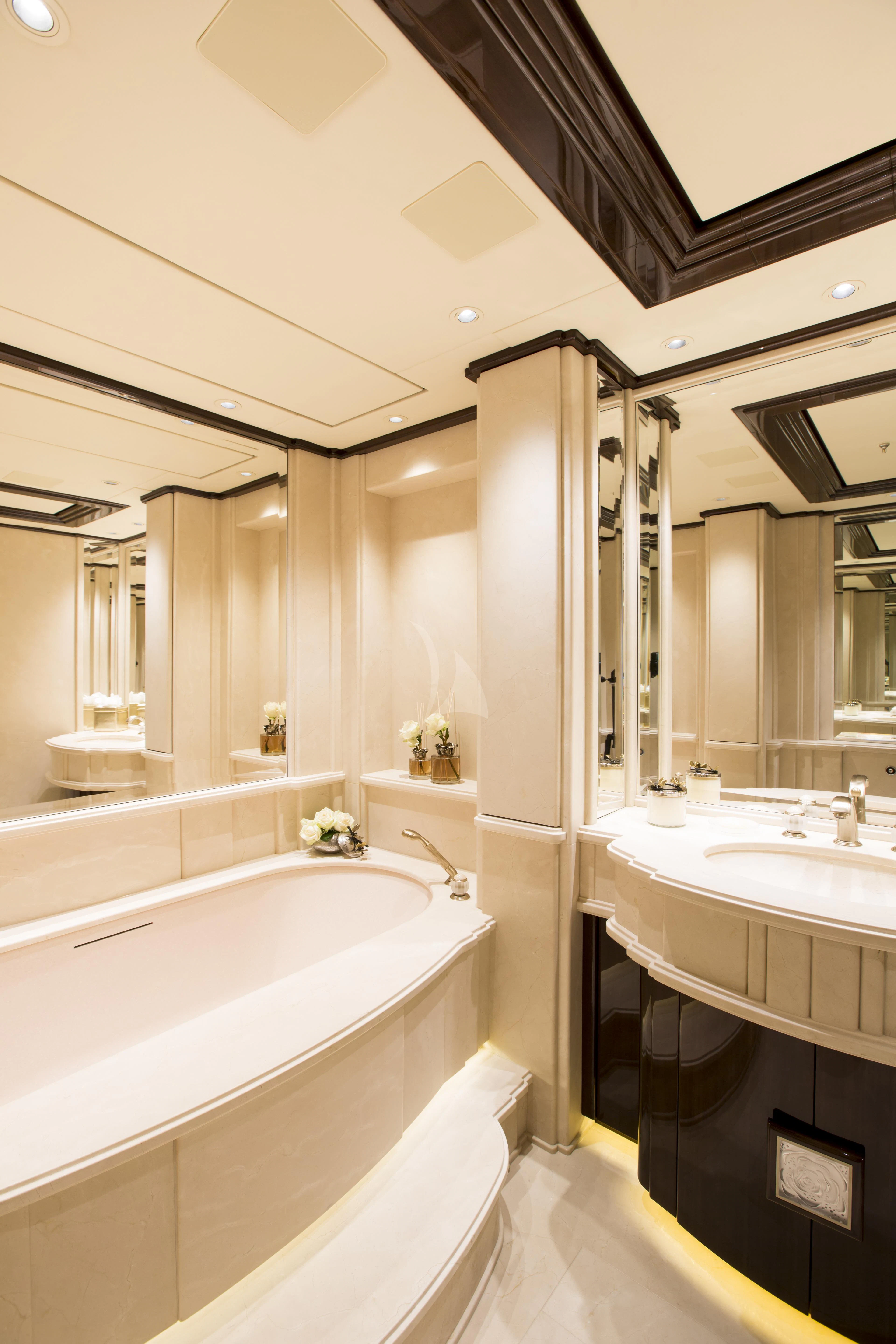 a bathroom with a tub sink and a sink aboard ILLUSION V Yacht for Charter