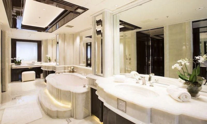 a bathroom with a large bathtub aboard ILLUSION V Yacht for Charter