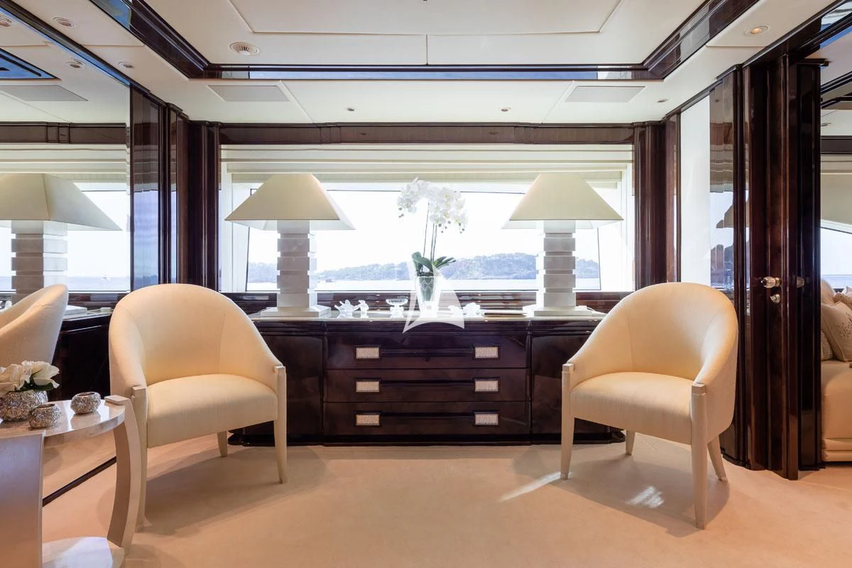 a room with a desk and chairs aboard ILLUSION V Yacht for Charter