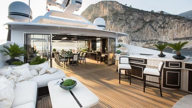 a living room with a large white table and chairs aboard ILLUSION V Yacht for Charter